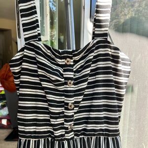 Size small Xhilaration black and white striped jumpsuit with brown buttons.